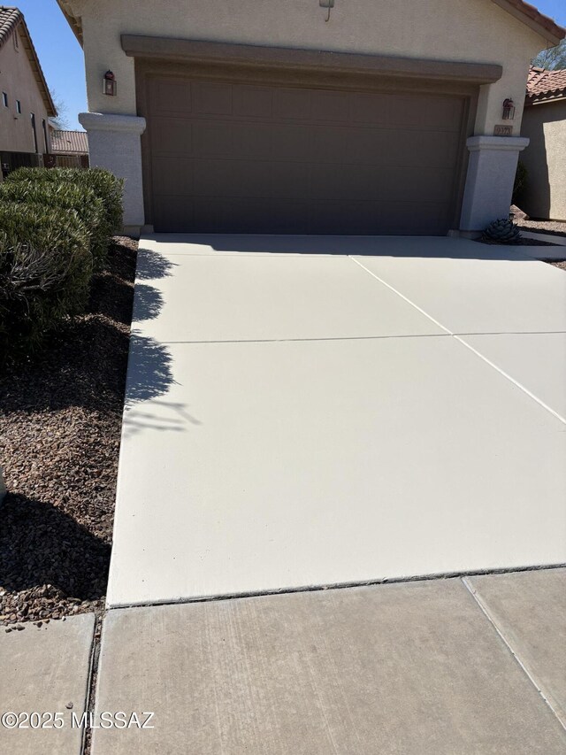 9373 N Sombrero Canyon Dr, Tucson, AZ 85743 - view of front of house with stucco siding and driveway