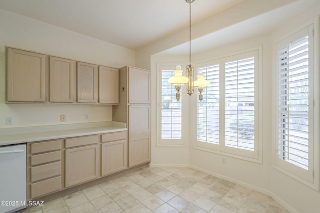 kitchen featuring a chandelier, plenty of natural light, light countertops, and dishwasher