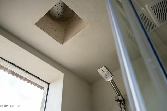 details featuring a heating unit and tiled shower