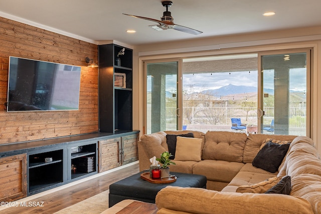 living room featuring recessed lighting, a mountain view, wood finished floors, and a ceiling fan