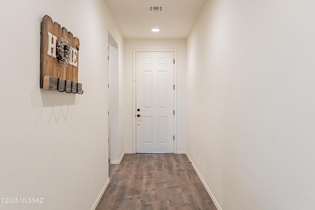 hall with recessed lighting, visible vents, baseboards, and wood finished floors