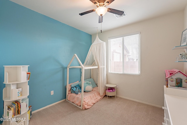 carpeted bedroom with baseboards, visible vents, and ceiling fan