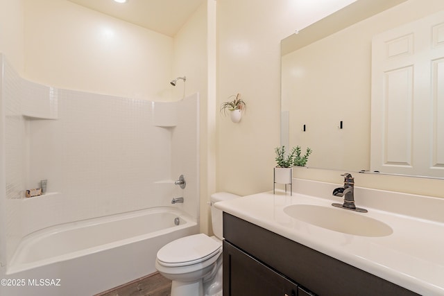 full bathroom featuring wood finished floors, toilet, shower / washtub combination, and vanity