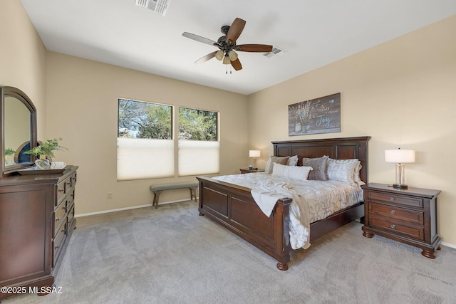 bedroom featuring ceiling fan, light colored carpet, visible vents, and baseboards