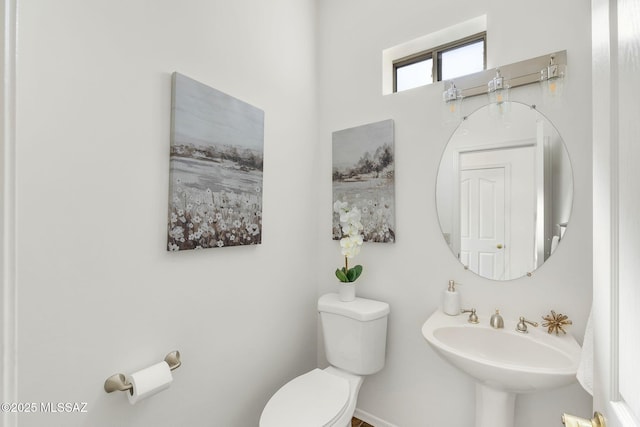 bathroom featuring toilet and a sink