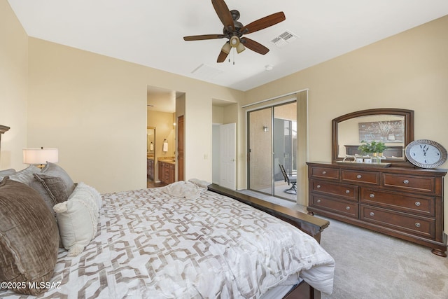 carpeted bedroom with a ceiling fan, visible vents, and connected bathroom