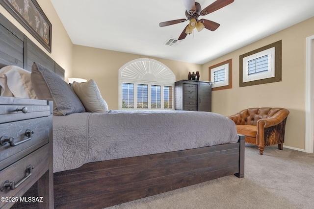 bedroom featuring visible vents, baseboards, a ceiling fan, and carpet flooring