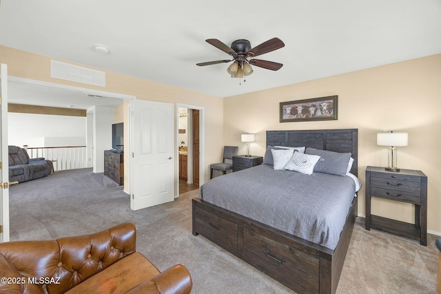 carpeted bedroom featuring a ceiling fan and visible vents