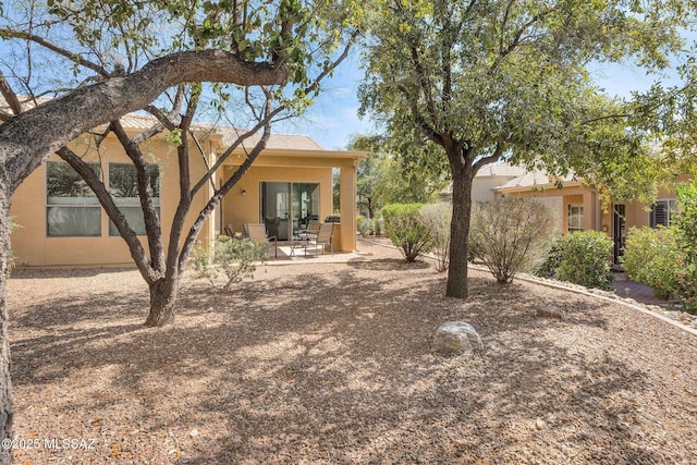 exterior space with a patio area and stucco siding