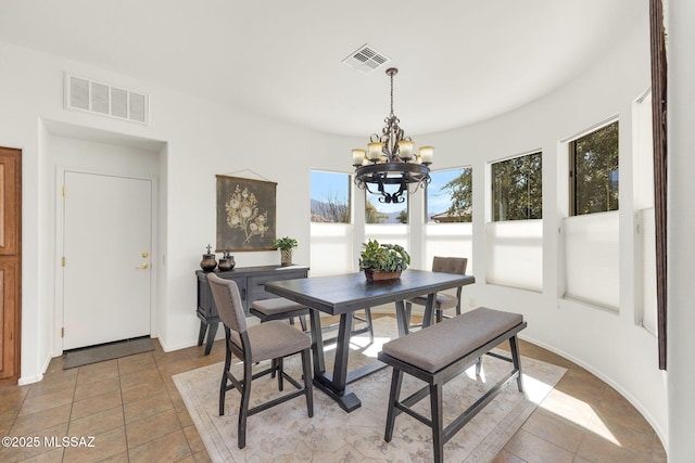 dining area with a chandelier, visible vents, baseboards, and light tile patterned floors