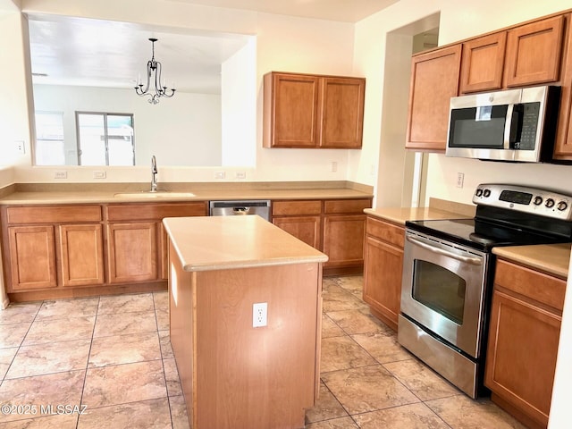 kitchen featuring stainless steel appliances, a sink, light countertops, and brown cabinets