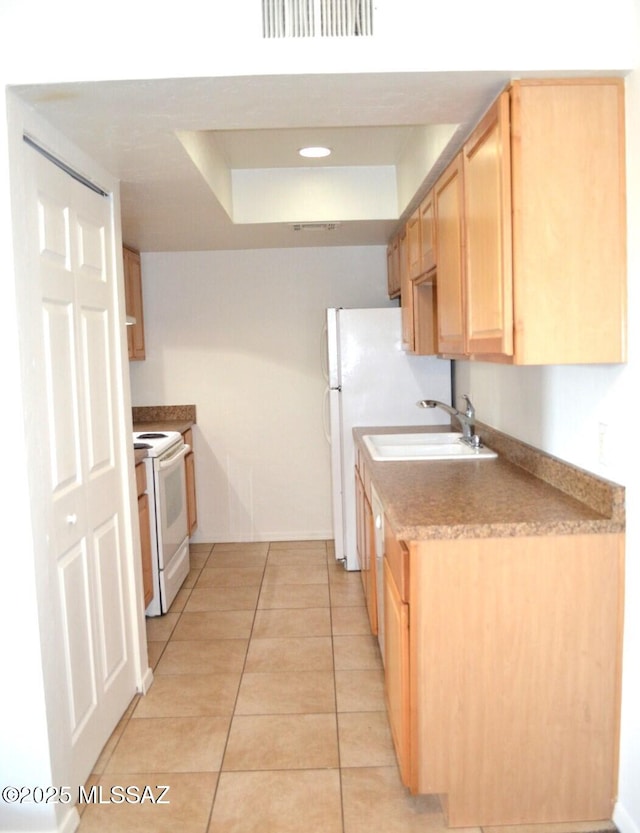 kitchen featuring light tile patterned floors, light brown cabinets, electric range, a sink, and visible vents