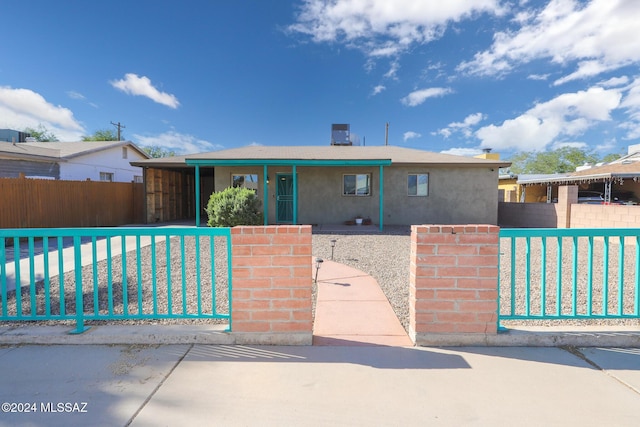 view of front of property featuring a fenced front yard and stucco siding