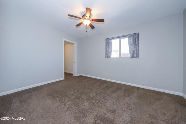 2608 E Warwick Vis, Tucson, AZ 85713 - spare room with dark carpet, ceiling fan, and baseboards