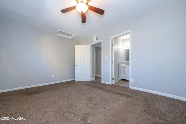2608 E Warwick Vis, Tucson, AZ 85713 - unfurnished bedroom featuring carpet flooring, baseboards, attic access, and connected bathroom