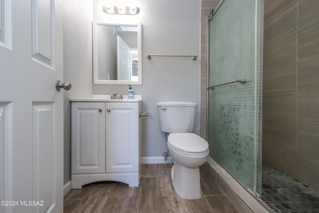 2608 E Warwick Vis, Tucson, AZ 85713 - bathroom featuring tiled shower, toilet, wood finished floors, vanity, and baseboards