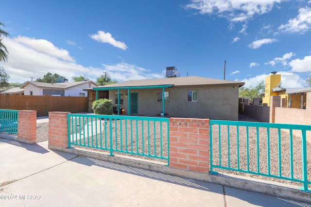 view of front of home featuring fence private yard and stucco siding