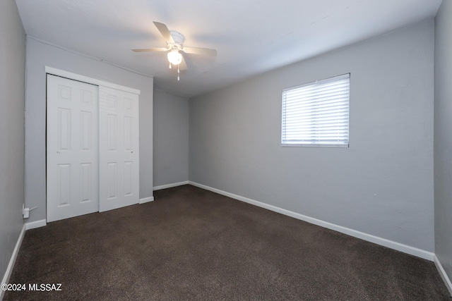 2608 E Warwick Vis, Tucson, AZ 85713 - unfurnished bedroom with baseboards, dark colored carpet, a closet, and ceiling fan