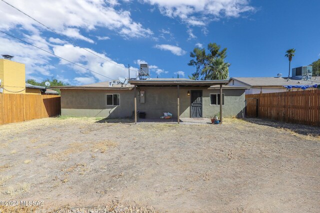 2608 E Warwick Vis, Tucson, AZ 85713 - back of house with a fenced backyard, central air condition unit, and stucco siding
