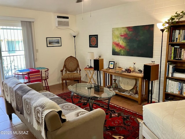 tiled living room featuring baseboards and a wall mounted AC