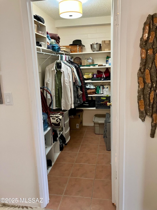 walk in closet with tile patterned flooring