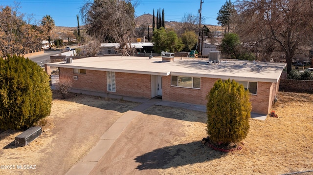 2724 N Green Pl, Nogales, AZ 85621 - view of front of property featuring dirt driveway, brick siding, and central AC unit