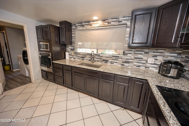 2724 N Green Pl, Nogales, AZ 85621 - kitchen featuring dark brown cabinetry, tasteful backsplash, stainless steel appliances, and a sink