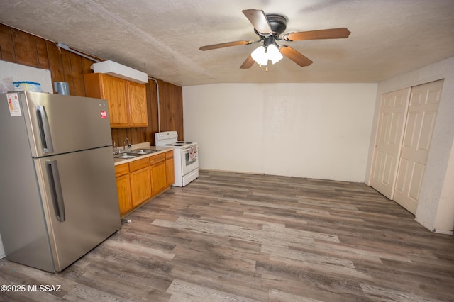 2724 N Green Pl, Nogales, AZ 85621 - kitchen featuring white range with electric cooktop, light countertops, freestanding refrigerator, a sink, and wood finished floors