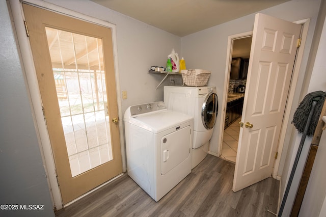 2724 N Green Pl, Nogales, AZ 85621 - clothes washing area with laundry area, washing machine and dryer, a wealth of natural light, and light wood-style floors