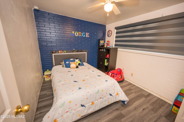 2724 N Green Pl, Nogales, AZ 85621 - bedroom with brick wall, a ceiling fan, and wood finished floors