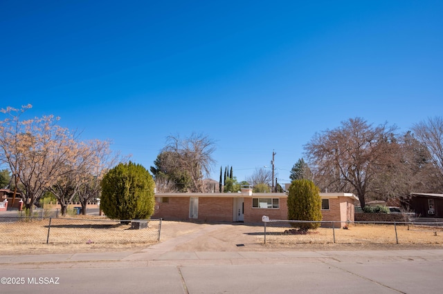 2724 N Green Pl, Nogales, AZ 85621 - ranch-style house featuring driveway, a fenced front yard, a chimney, and brick siding