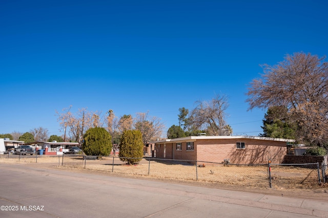 2724 N Green Pl, Nogales, AZ 85621 - view of front of house with driveway, a fenced front yard, a carport, and brick siding