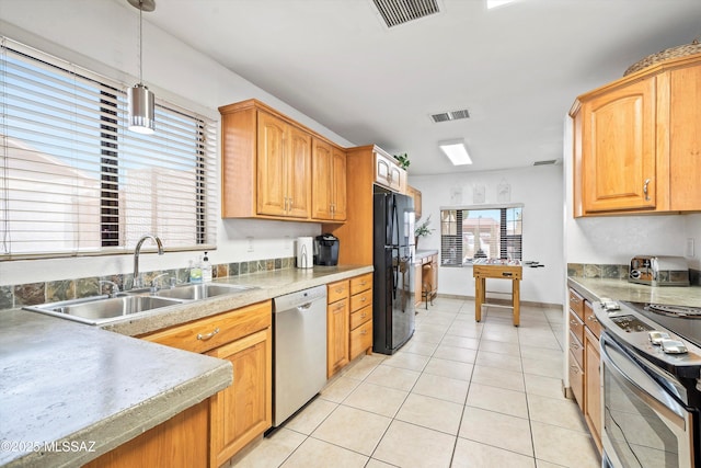 kitchen featuring light tile patterned floors, appliances with stainless steel finishes, a sink, and visible vents