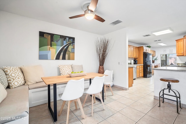 dining room featuring breakfast area, visible vents, ceiling fan, and light tile patterned floors