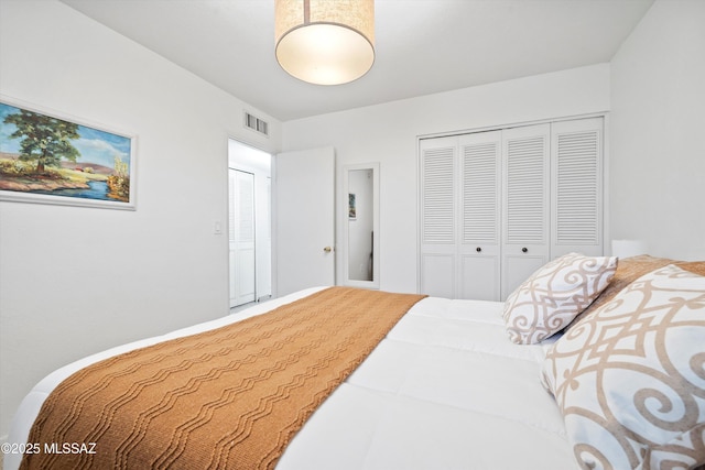 bedroom featuring a closet and visible vents