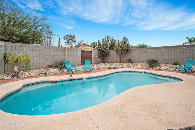 view of pool with a fenced in pool, a fenced backyard, and a patio