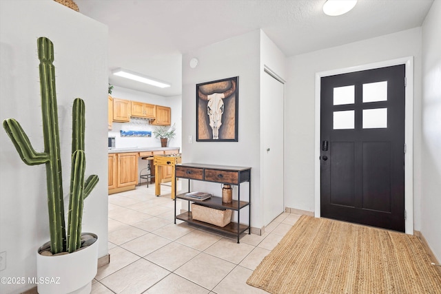 entrance foyer featuring light tile patterned floors