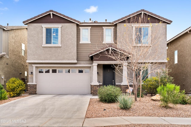 view of front facade with stucco siding, concrete driveway, an attached garage, stone siding, and a tiled roof