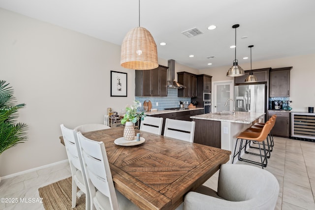 dining area with wine cooler, visible vents, baseboards, and recessed lighting