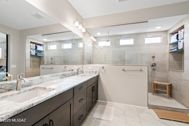 full bathroom featuring walk in shower and a sink