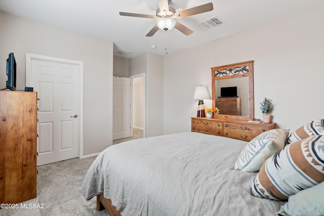 carpeted bedroom featuring ceiling fan and visible vents