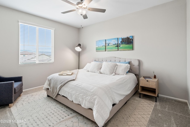 bedroom featuring light carpet, ceiling fan, and baseboards