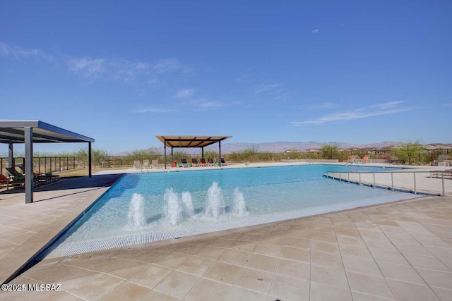 community pool featuring a patio area and a mountain view