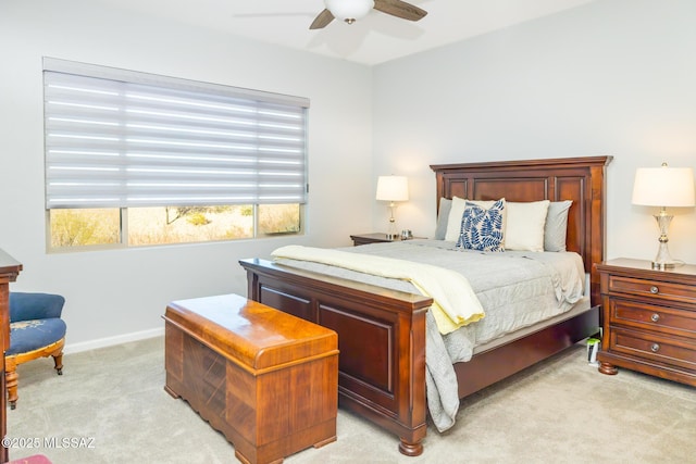 bedroom with ceiling fan, baseboards, and light colored carpet