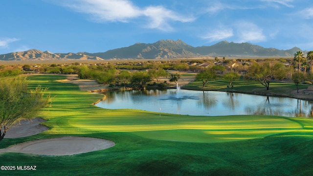 view of community with golf course view and a water and mountain view