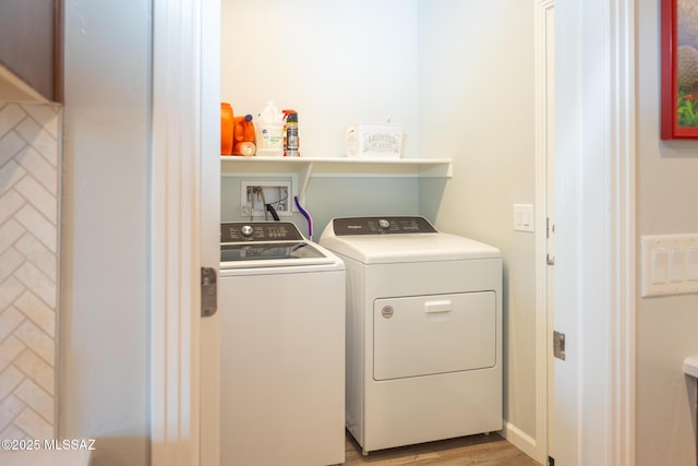 laundry room with laundry area, light wood-style flooring, and washer and dryer