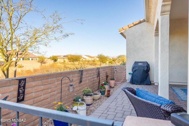 view of patio / terrace with grilling area and a fenced backyard