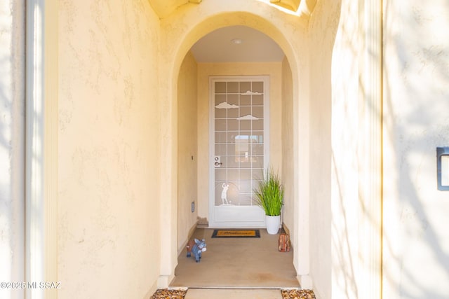 property entrance with stucco siding