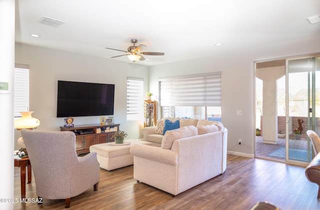 living area featuring recessed lighting, visible vents, a ceiling fan, wood finished floors, and baseboards