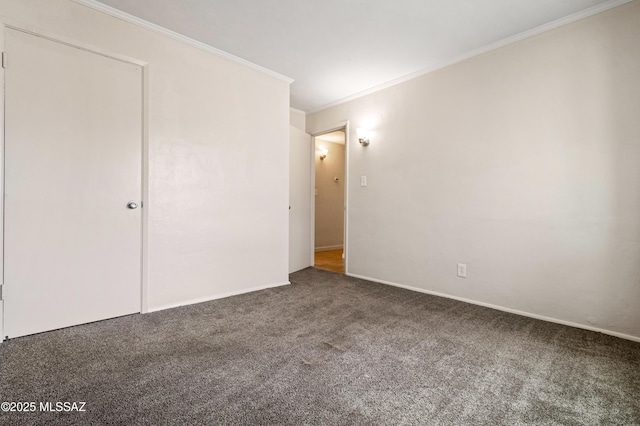 unfurnished bedroom featuring ornamental molding, carpet flooring, and baseboards